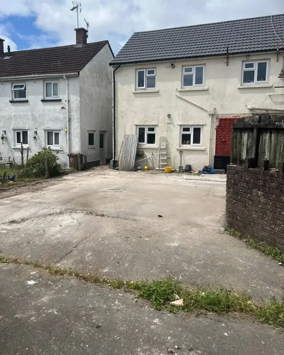The same yard cleared back to a bare concrete slab
